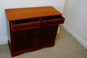 A golden Yew console table with two drawers at the top and a cupboard below