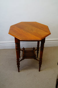 A lovely antique antique Edwardian octagonal shaped occasional table with a lowered shelf