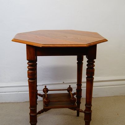 A lovely antique antique Edwardian octagonal shaped occasional table with a lowered shelf