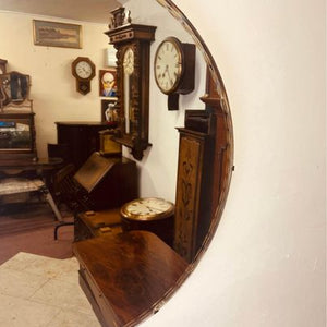 A large circular bevelled edged mirror with its original hanging chain circa 1930