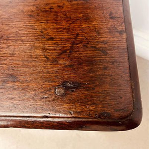 A period oak side table dating from the early 18th century, with a pegged two plank top