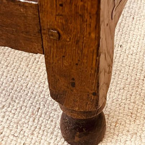 A period oak side table dating from the early 18th century, with a pegged two plank top