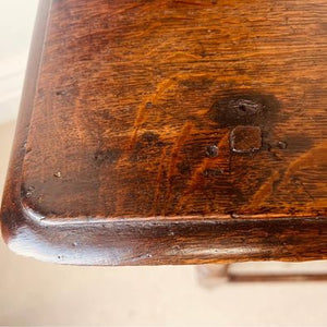 A period oak side table dating from the early 18th century, with a pegged two plank top