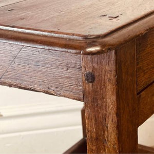 A period oak side table dating from the early 18th century, with a pegged two plank top