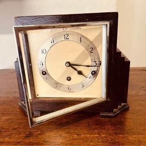 A very decorative Art Deco mantel clock in an ebonised stepped case c1930