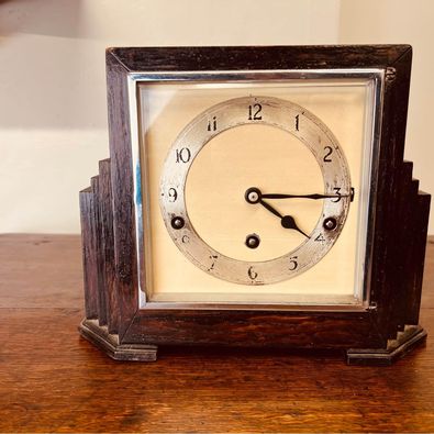 A very decorative Art Deco mantel clock in an ebonised stepped case c1930