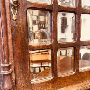 A fantastic solid oak cabinet with twelve individual double bevelled glass panel