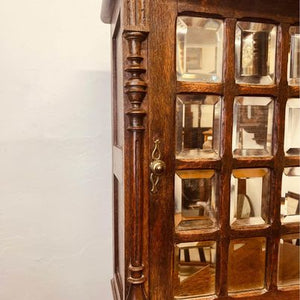 A fantastic solid oak cabinet with twelve individual double bevelled glass panel