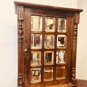 A fantastic solid oak cabinet with twelve individual double bevelled glass panel