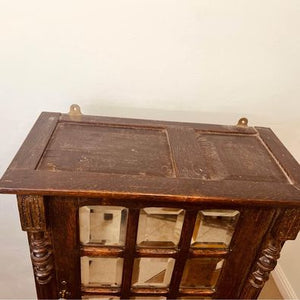 A fantastic solid oak cabinet with twelve individual double bevelled glass panel