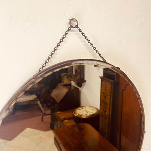 A large circular bevelled edged mirror with its original hanging chain circa 1930