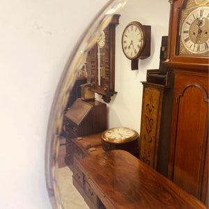 A large circular bevelled edged mirror with its original hanging chain circa 1930