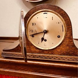 An ornate mahogany wooden Napoleon Hat mantle clock with Westminster chime