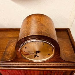 An ornate mahogany wooden Napoleon Hat mantle clock with Westminster chime