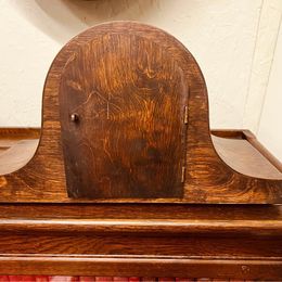 An ornate mahogany wooden Napoleon Hat mantle clock with Westminster chime