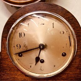 An ornate mahogany wooden Napoleon Hat mantle clock with Westminster chime