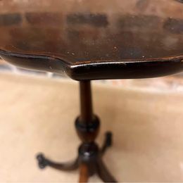 Antique oval mahogany wine table ,the carved piecrust top above a revolving turned stem