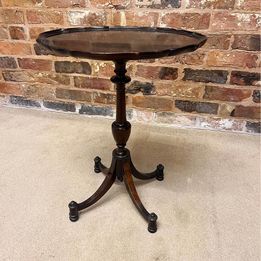 Antique oval mahogany wine table ,the carved piecrust top above a revolving turned stem