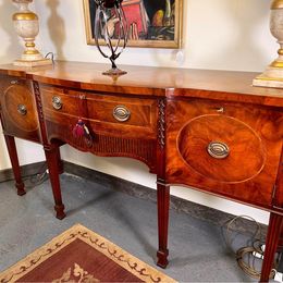 An outstanding solid mellow mahogany serpentine sideboard by renowned 'Titchmarsh and Goodwin'