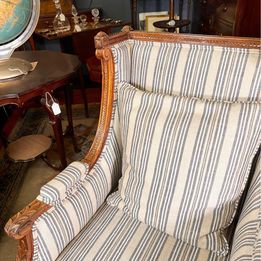 A French Louis XVI style walnut bergères chair from the 20th century in fabulous condition