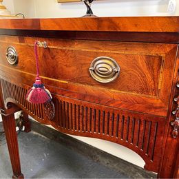 An outstanding solid mellow mahogany serpentine sideboard by renowned 'Titchmarsh and Goodwin'