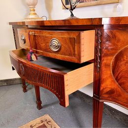 An outstanding solid mellow mahogany serpentine sideboard by renowned 'Titchmarsh and Goodwin'