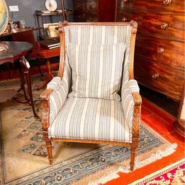 A French Louis XVI style walnut bergères chair from the 20th century in fabulous condition