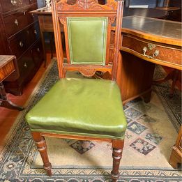 An antique decorative carved and turned Victorian leather office chair