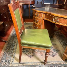 An antique decorative carved and turned Victorian leather office chair