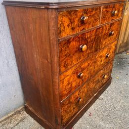 An antique Victorian walnut chest of drawers, faced with burr walnut fronts