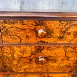 An antique Victorian walnut chest of drawers, faced with burr walnut fronts