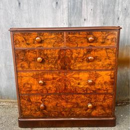 An antique Victorian walnut chest of drawers, faced with burr walnut fronts