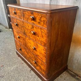 An antique Victorian walnut chest of drawers, faced with burr walnut fronts