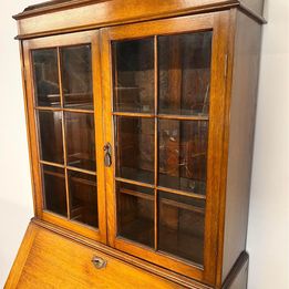 A Lovely Arts And Crafts Oak Bureau Bookcase with tooled leather writing area