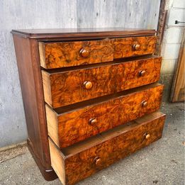 An antique Victorian walnut chest of drawers, faced with burr walnut fronts