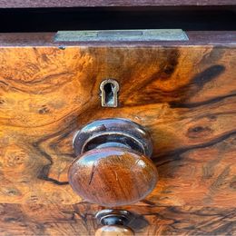 An antique Victorian walnut chest of drawers, faced with burr walnut fronts