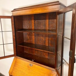 A Lovely Arts And Crafts Oak Bureau Bookcase with tooled leather writing area