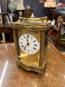 A handsome fully glazed classic Corniche style polished brass carriage clock with a fine white enamel dial