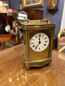 A handsome fully glazed classic Corniche style polished brass carriage clock with a fine white enamel dial