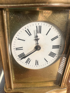 A handsome fully glazed classic Corniche style polished brass carriage clock with a fine white enamel dial