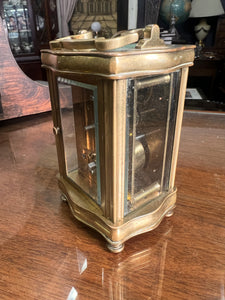 A handsome fully glazed classic Corniche style polished brass carriage clock with a fine white enamel dial