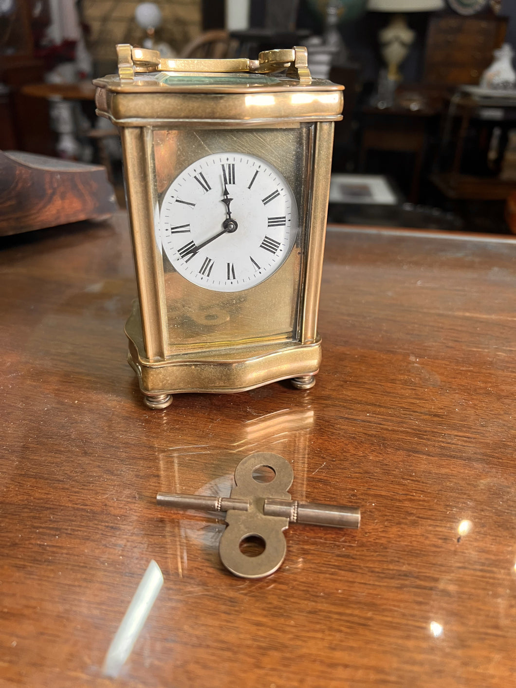 A handsome fully glazed classic Corniche style polished brass carriage clock with a fine white enamel dial