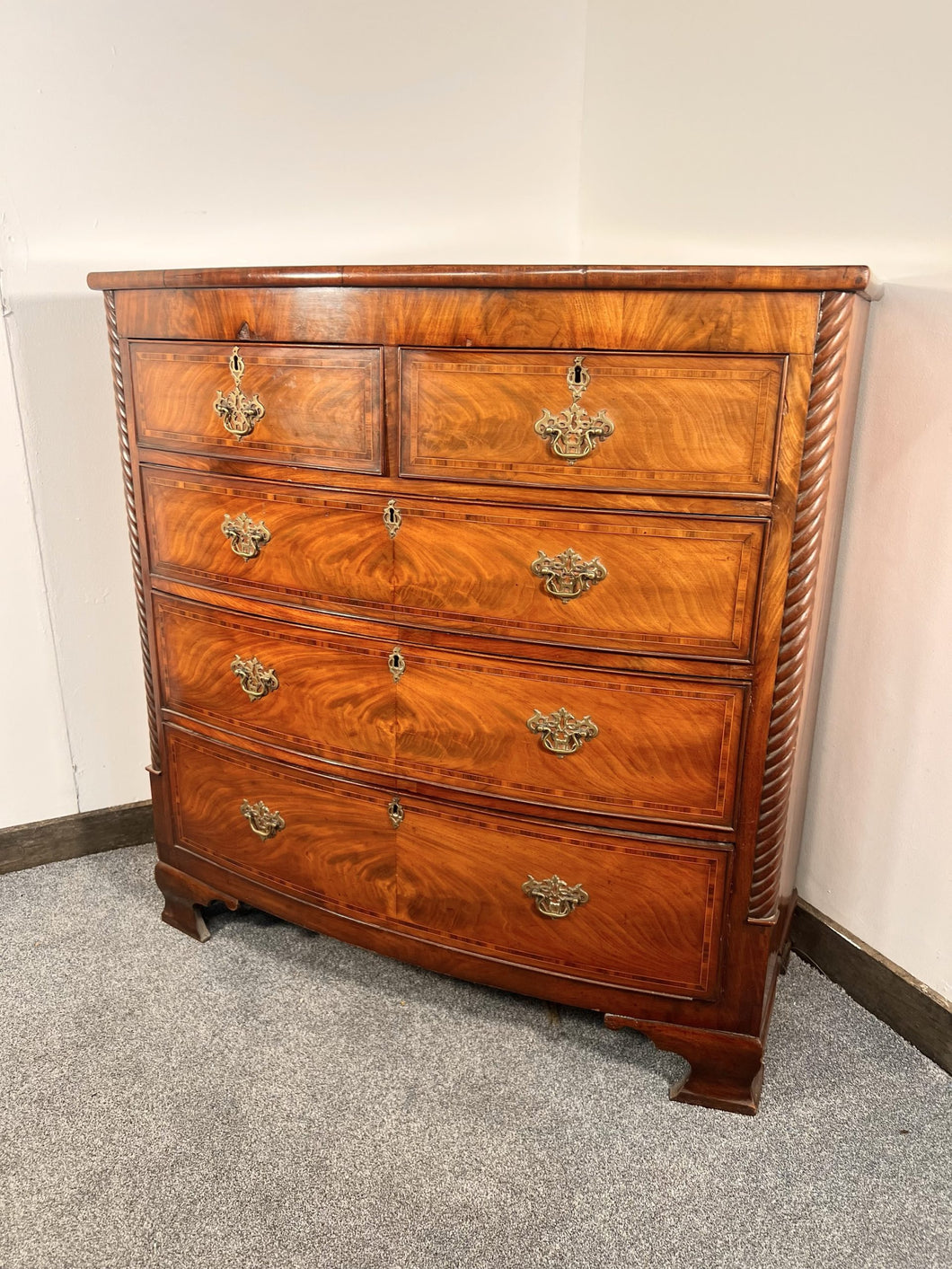 An Empire Bow Front Five Drawer Chest With Rope Turned Columns
