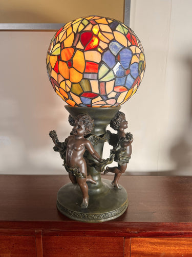 A Widdop Bingham And Co Bronze Figural Table Lamp With Tiffany Stained Glass Shade