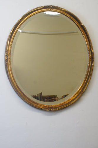 Gilded mirror with bevelled glass and beautifully decorated frame