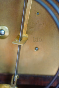 A mahogany mantle clock with the most fabulously engraved face