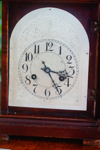 A mahogany mantle clock with the most fabulously engraved face