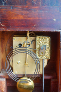 A mahogany mantle clock with the most fabulously engraved face