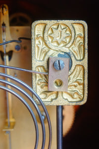 A mahogany mantle clock with the most fabulously engraved face