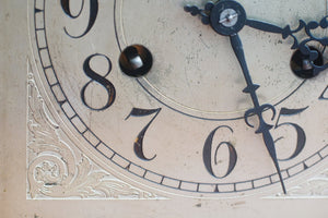 A mahogany mantle clock with the most fabulously engraved face